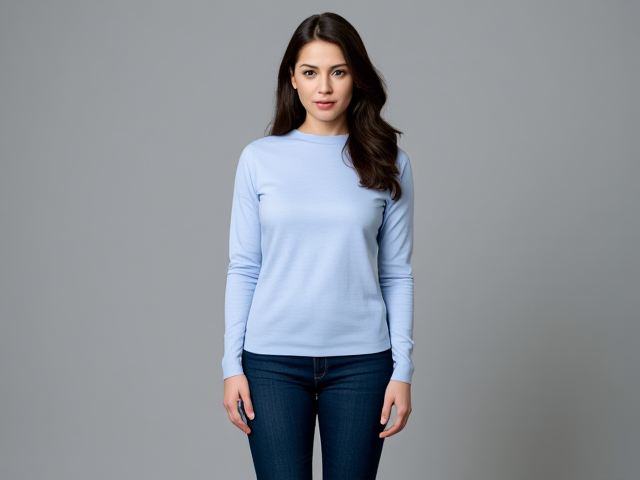 Brunette dark hair wearing a light blue long sleeve top and dark blue skinny jeans full body view