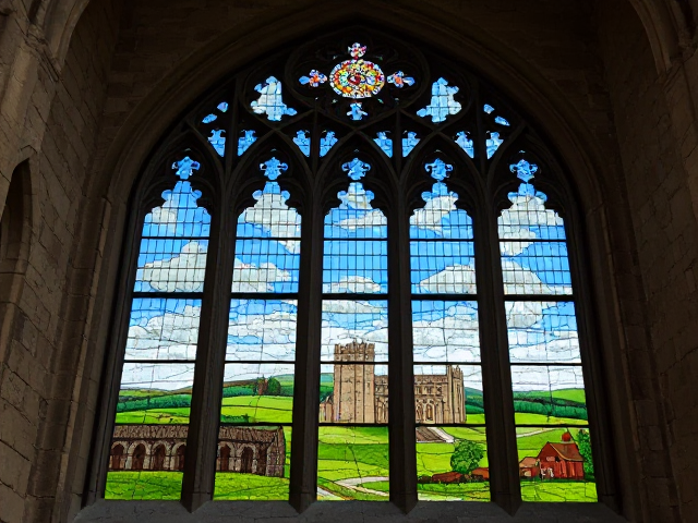 A medieval stained glass of Glastonbury Abbey on the Tor.
